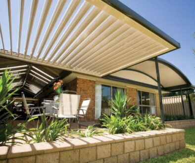 Modern low-maintenance patio with powder-coated roofing and landscaped garden in a Melbourne backyard