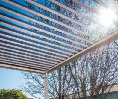 A Stratco outdoor Sunroof with its aluminium louvres tilted open to the sun